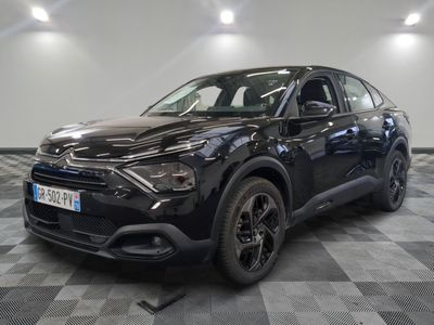 la voiture noire est garée dans le garage sur un sol en damier