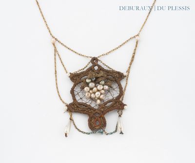 an image of a close up of a necklace on a white surface