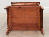 an old wooden chair with a wooden seat on the floor