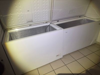 a white chest freezer sitting in the corner of a room