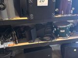 a lot of musical equipment on the shelves in the room
