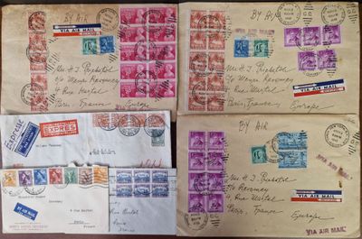 several old envelopes are sitting on top of a wooden table