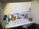 a shelf that has a lot of cleaning products on it
