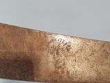 a large knife that has been cut in half with a sharp blade