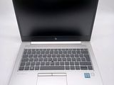 an open laptop computer sitting on top of a white table
