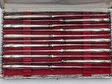 a silver box with a bunch of silver spoons in it