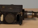 an old camera sitting on a wooden table