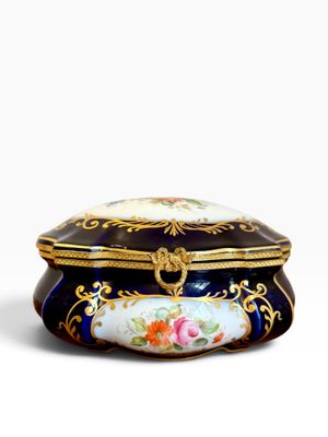 an image of a blue and gold box with flowers on it