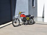 a red motorcycle parked in front of a building