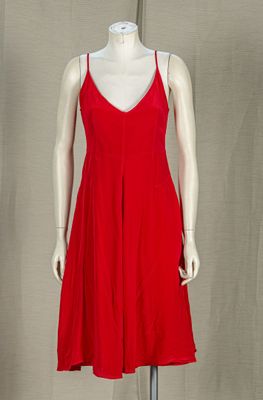 a mannequin wearing a red dress on a mannequin stand