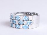 a close up of a ring with blue and white stones