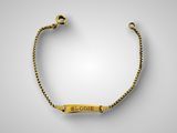 a gold plated bracelet with a nameplate on it