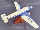 a small model of a plane on a wooden stand