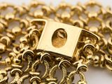 a close up of a gold chain with a square clasp