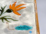a small table with a painted flower design on it