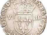 a silver coin with a crown on top of it