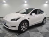a picture of a white tesla model y in a showroom
