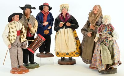 five figurines of people dressed in traditional clothing