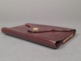 wallet case made of brown leather with a gold clasp