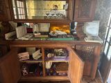 a wooden cabinet with a mirror on top of it