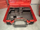 a red tool box with tools in it on a table