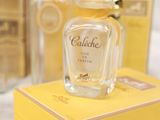 a bottle of cologne sitting on top of a yellow box