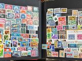 a open book with stamps on it on a table