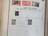 an open book with stamps on it on a table