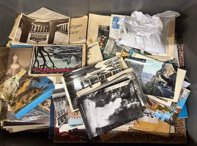 a box full of old photos of people and buildings