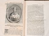 an open book with a picture of a man in a nun ' s robes on it