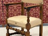 a wooden chair with a beige upholstered seat