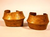 pair of antique brass vases with designs on them