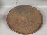 a brown plate with a wire hanging from it ' s side