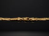 a gold bracelet on a black background
