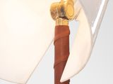 a close up of a lamp with a brown leather handle