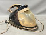 a black and gold steam iron sitting on a white surface