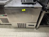 a machine that is sitting in a kitchen next to a sink