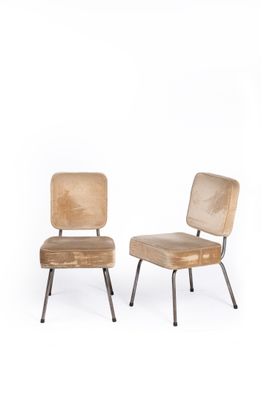 pair of mid - century style chairs with upholstered backrests and metal legs