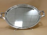 a silver tray with a mirror on it on a table