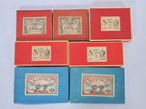 four boxes with stamps on them sitting on a white surface