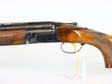 a close up of a rifle on a white surface with a white background