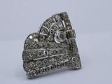 a close up of a diamond ring on a white surface