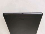 the back of a black tablet computer sitting on top of a table