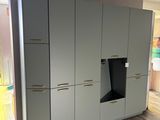 an image of a kitchen with a large cabinet in the middle of the room