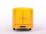 a yellow toy bus that is sitting on a white surface