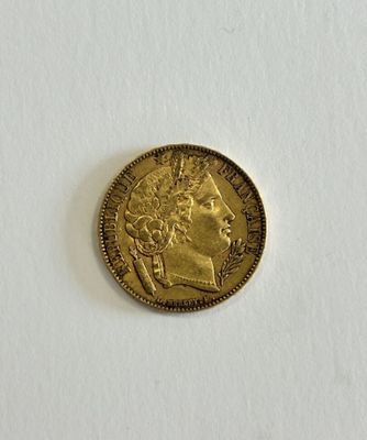 a close up of a gold coin on a white surface