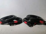 two black and red cables sitting next to each other on a table