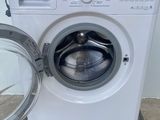a washing machine sitting on a pallet with the door open