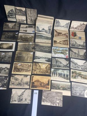 some old postcards are on a black table with a white sticker