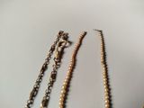three different types of necklaces are displayed on a white surface